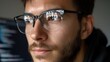 © Kliapko_Photo - Concentrated developer with glasses, programming with reflections of data on their lenses.