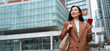 © Stock 4 You - Asian businesswoman using smartphone on city street, professional career woman checking online banking and finance apps, walking at business office buildings in urban downtown. Web banner, copy space