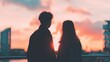 © tashechka - Couple watching sunset from balcony in city during evening hours