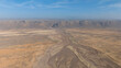 © M - Aerial Desert Valley with Dry Riverbed and Mesa Cliffs
