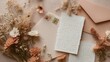 © fivan - A soft peach backdrop flat lay with handwritten recipe cards, blush envelopes, and scattered dried florals under bright diffused daylight