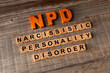 © Fotema - NPD abbreviation and its individual words: Internal Narcissistic Personality. Rustic wooden background.