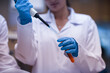 © .shock - Young doctors and medical technicians performing blood testing and pipetting in a clinical laboratory