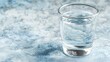 © slamet - Glass of water on a textured surface