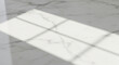 © malik - A close-up view of a white marble surface with gray veins and a window reflection