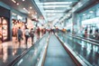 © Sg - Blurred view of people walking in a modern shopping mall with moving walkway.
