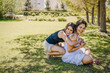 © Brand - Mother and daughter embracing and smiling in park