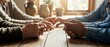 © Yuliia - Elderly couple holding hands across wooden table in warm sunlight streaming through window creating intimate moment of love and connection in cozy home setting.