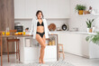 © Pixel-Shot - Attractive young Asian woman wearing black underwear and shirt in kitchen