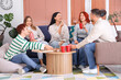 © Pixel-Shot - Group of young friends with beer and snacks resting at home