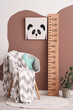 © Pixel-Shot - Interior of stylish children's room with wooden stadiometer, armchair and cute animal painting