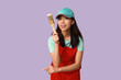 © Pixel-Shot - Female Asian painter with brush on purple background