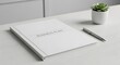 © SWPIC - White business plan book with pen and succulent plant on desk