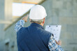 © auremar - male builder in hard hat with clipboard