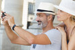 © auremar - happy mature couple taking photo outdoors