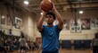 © KarpenArt Studio - Focused young basketball player preparing to shoot in a gymnasium