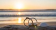 © Yusuf - Wedding rings on driftwood with seashell against sunset ocean view
