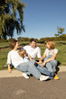 © Anna - happy family enjoys moment together in park under a cloudless sky. Well-being, positive thinking, dreams. Spring walks outdoors. Children of different ages and parents express joy, unity, happiness
