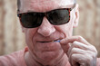 © Alex - A man uses a dental brush for its intended purpose
