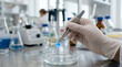 © romagumy - Scientist conducts experiment with glowing sample in laboratory setting under bright lights