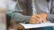 © arrowsmith2 - Close-up of Student Writing on OMR Answer Sheet in Final Exam