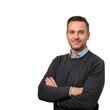© Pixel - Professional man standing with arms crossed against a plain background