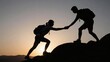 © Studicon - Silhouette of two hikers reaching a helping hand while climbing a mountain at sunrise