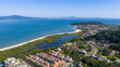 © Marcio Eneas - Ponta das Canas beach with sheltered lagoon, lush vegetation and blue sea in Florianopolis.