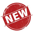 © Mim - Red circular stamp with white text N E W