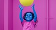 © Breezze - Joyful Child With Blue Skin and Curly Hair Reaching and Playing With a Yellow Ball in a Pink Gym Setting for Youth Sports and Educational Marketing