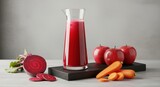 Glass pitcher of fresh red vegetable and fruit juice with beets, apples, and carrots
