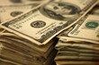 © juliars - Close up of a stack of one hundred dollar bills suggesting savings, investment, and financial success
