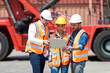 © NVB Stocker - Hispanic man harbor worker talking on the walkie-talkie radio and control loading containers at container warehouse. container yard port of import and export goods