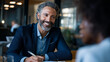 © Julia - Consultant interviewing corporate client in an office meeting to discover workflow inefficiencies and pain points during a focused business discovery session
