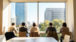 © Rahman - Back view of diverse business people looking out a large window at a sunny city skyline with modern buildings