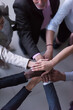 © .shock - Business team joining hands in a diverse office showing teamwork, collaboration and unity