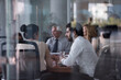 © .shock - Business meeting in modern office with colleagues collaborating around a conference table