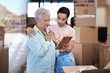 © peopleimages.com - New home, frame and woman with senior mother for help with boxes, furniture and unpacking. Retirement, homeowner and daughter console elderly mom for property, relocation and picture for memory