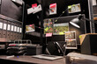 © DC Studio - Empty dark police detective room with murder case investigation process on board. Suspect photographs connected with clues hanging on wall and file folders on racks in investigator agency office