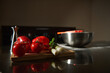 © Taras Grebinets - Fresh Tomatoes and Bell Pepper on a Cutting Board With Scallions and Stainless Bowl in Kitchen
