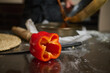 © Taras Grebinets - Red Bell Pepper on Kitchen Countertop with Rolling Pin and Bowl During Food Preparation