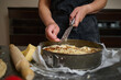 © Taras Grebinets - Homemade Cheese Pie Being Prepared by Hands in a Kitchen With Rolling Pin and Apron