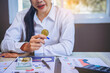 © Panumas - Businessman holding Bitcoin for digital currency trading at his workplace. Bitcoin and digital money concept.