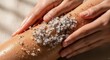 © yh702 - Close-up of Hands Applying Exfoliating Scrub to Leg for Skincare.
