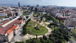 © bydronevideos - Estacion Del Nord Park In Barcelona Catalonia Spain. Drone Captures A Garden With Sidewalks Surrounded By Lush Trees. Industry Skyline Commercial Building Awesome.