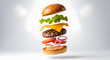 © Bery - Exploded view of a classic hamburger with all ingredients floating in mid-air against a clean white background