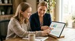 © Chayada - Financial advisor helping young woman review portfolio charts on tablet showing investment education planning confidence and future wealth goals
