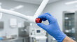 © Moonroad - Adjusting medical equipment with gloved hand in clinical environment, showing precision and care in healthcare setting