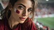 © Marco - Euphoric woman in a football stadium with her face painted with the colors of the Qatari flag, cheering and supporting her team.