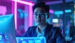 © Erni - Asian Man in Glasses Working on Computer in Neon Lit Office.